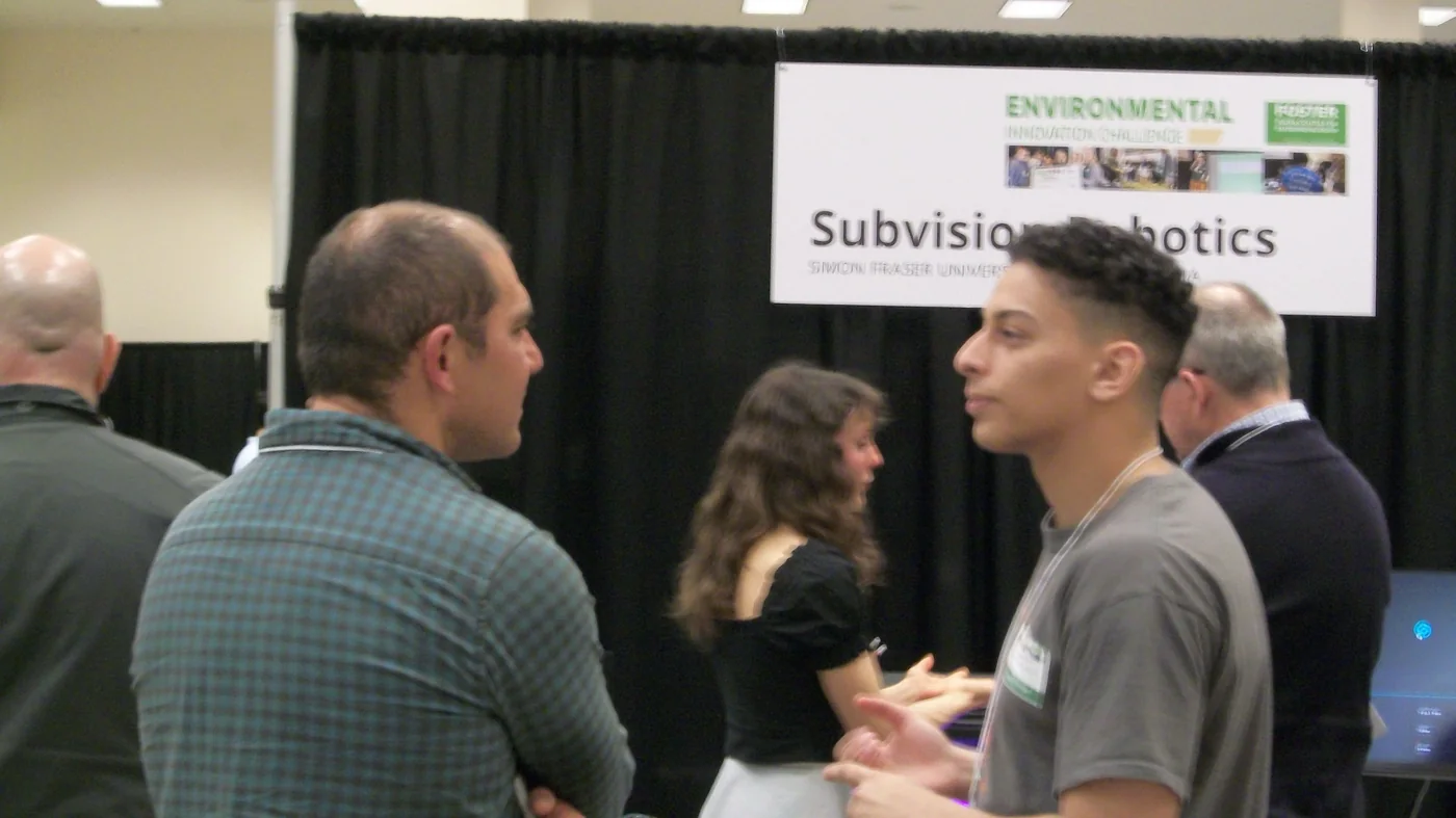 Subvision representative speaking at a booth