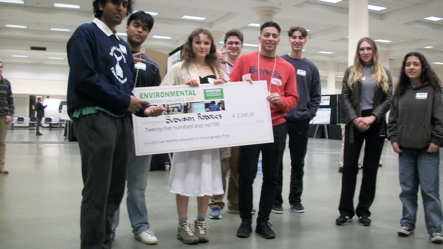 Subvision team with award check