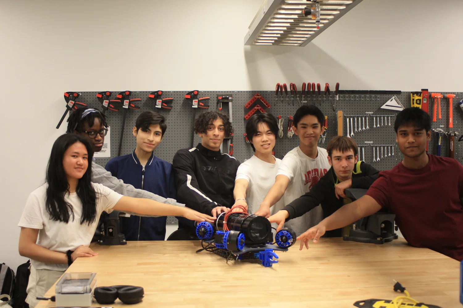 Subvision team around a rover in the lab